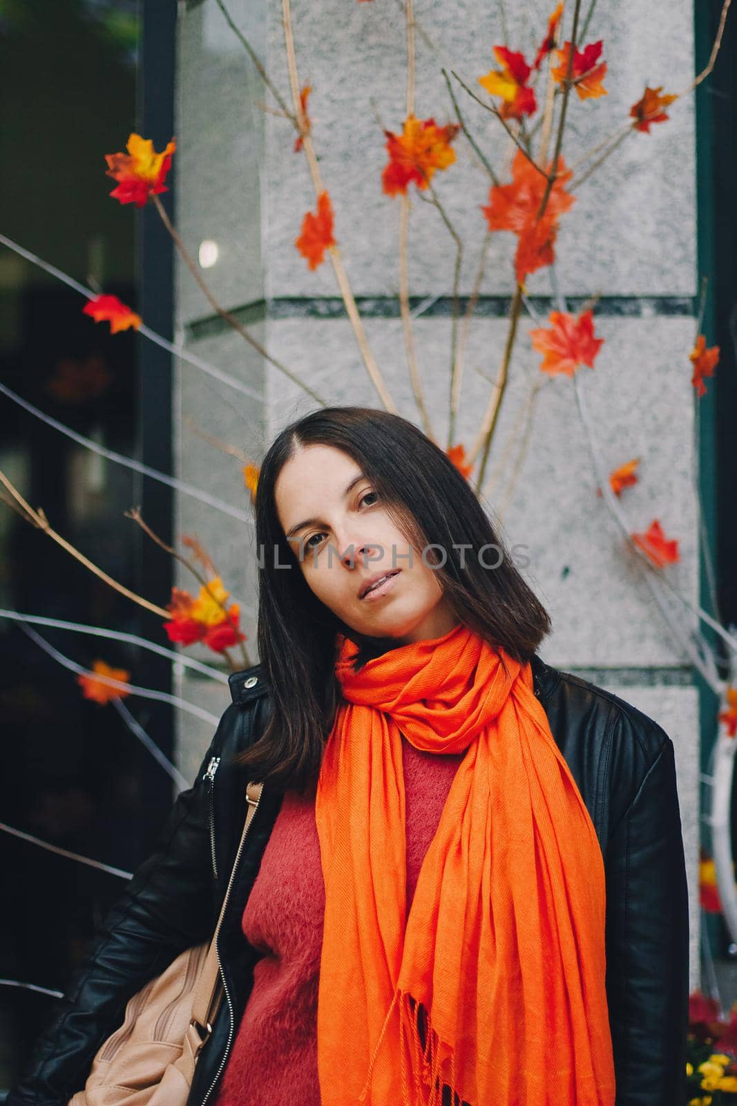 Portrait of a happy woman in bright orange scarf in the city. by mmp1206