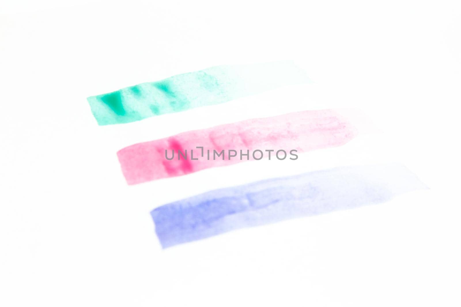 Collection of green, pink and purple smears of acrylic paint isolated on white background.