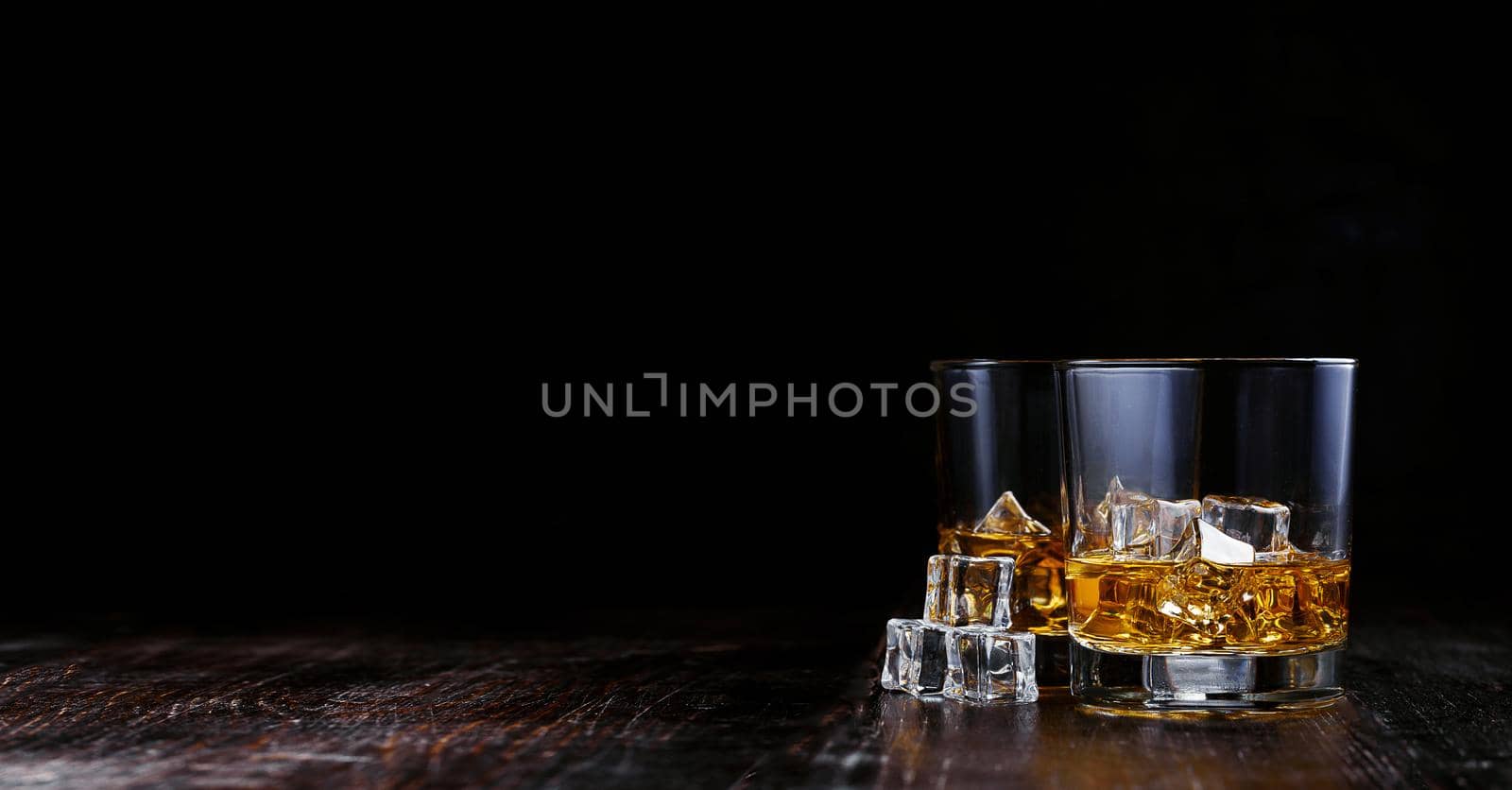 whiskey with ice in modern glasses by vvmich