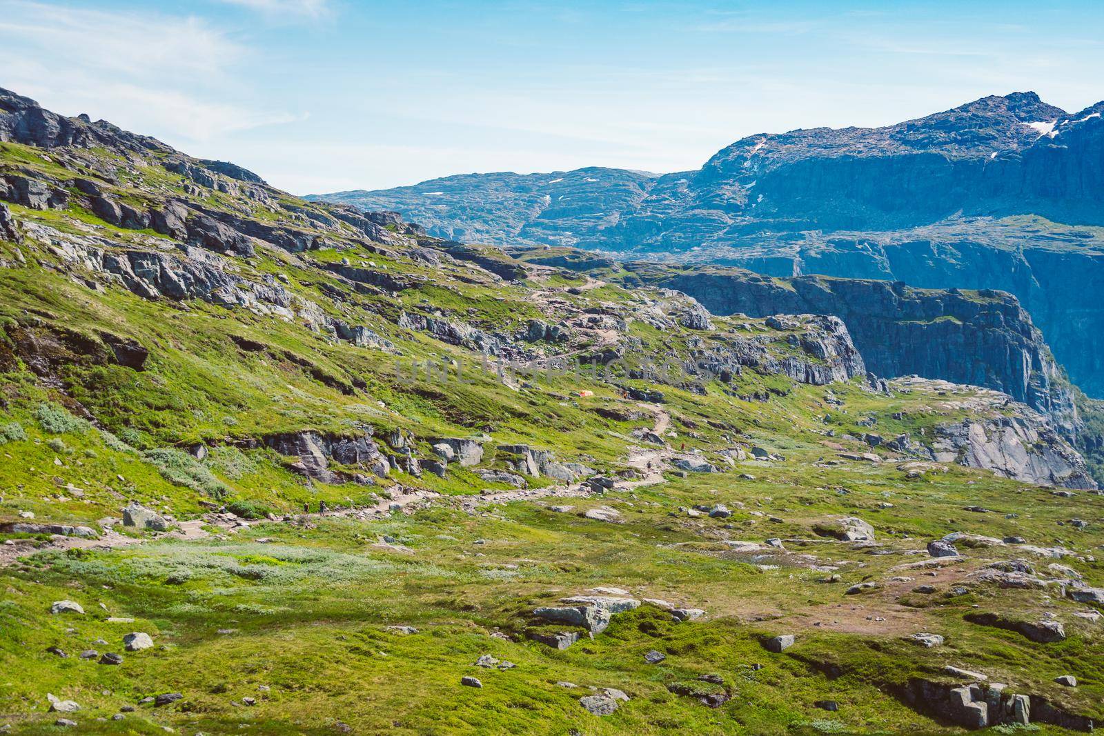 July 26, 2019. Norway tourist route on the trolltunga. People tourists go hiking in the mountains of Norway in fine sunny weather to thetrolltunga. Hiking backpack theme.