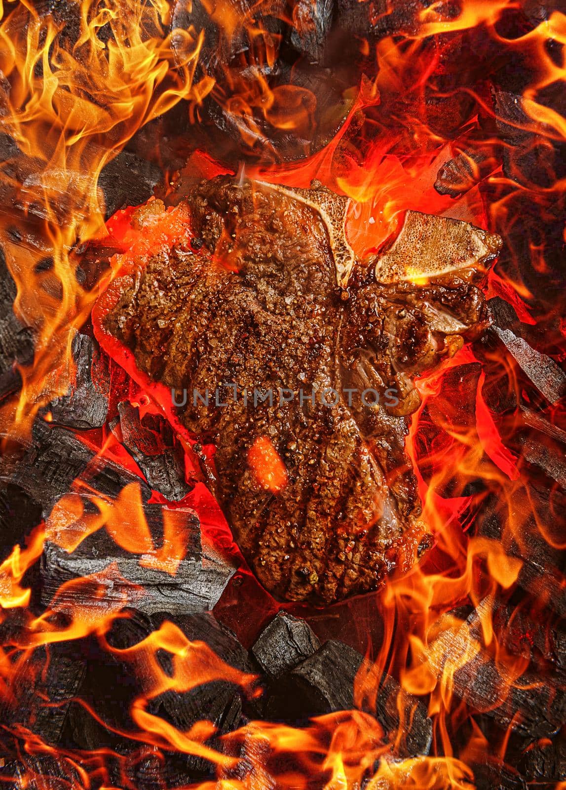 grilled marbled beef steak with coals and smoke by vvmich