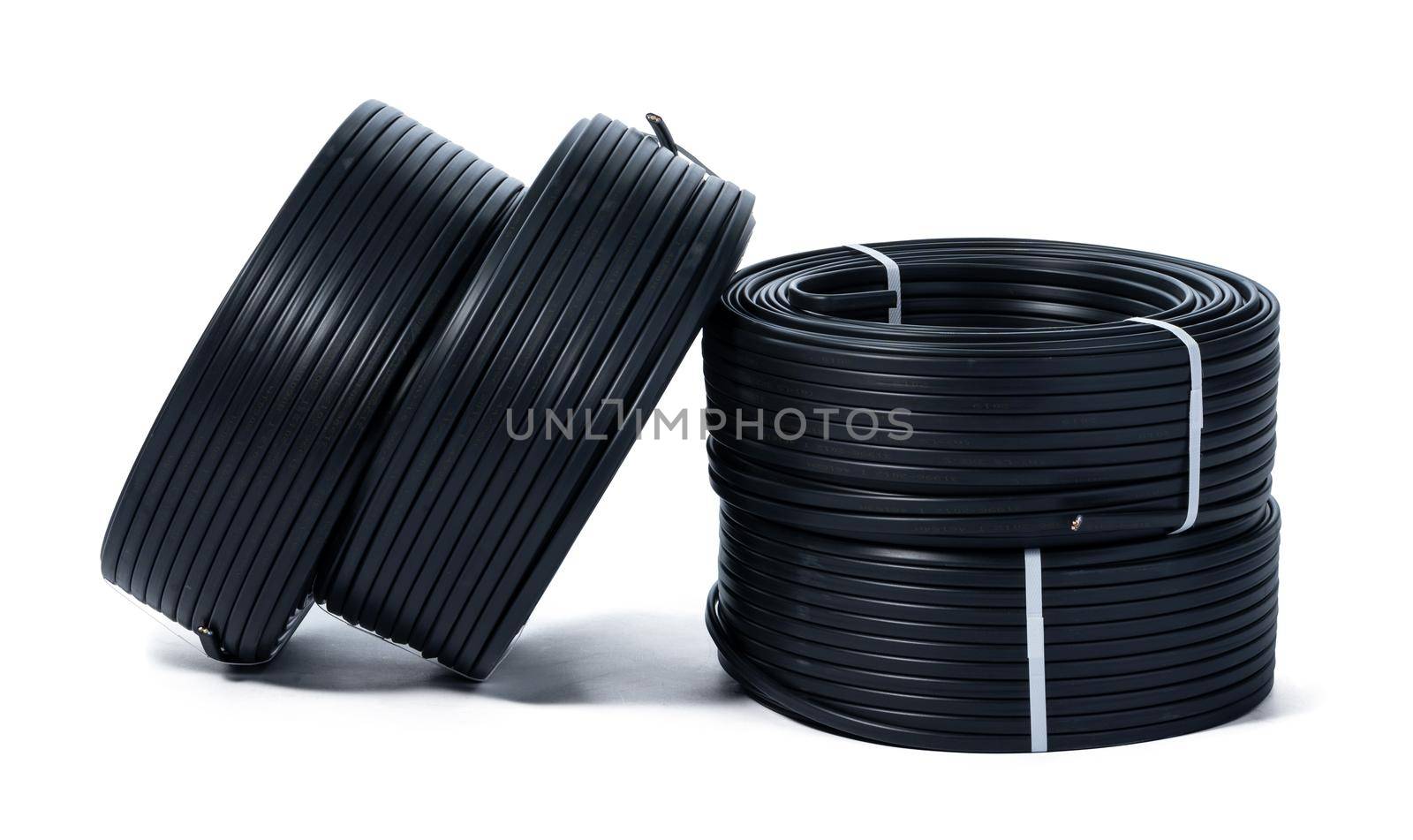 Coils of black cable isolated on white background. Close up.