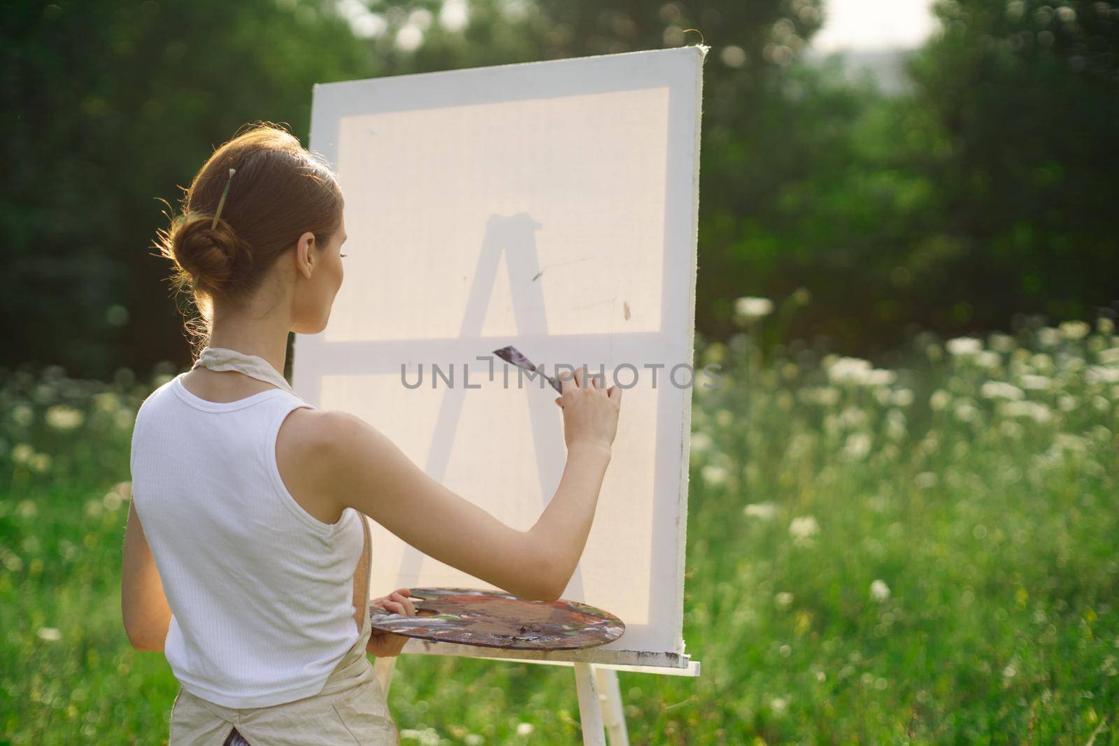 woman artist outdoors paint palette painting landscape. High quality photo