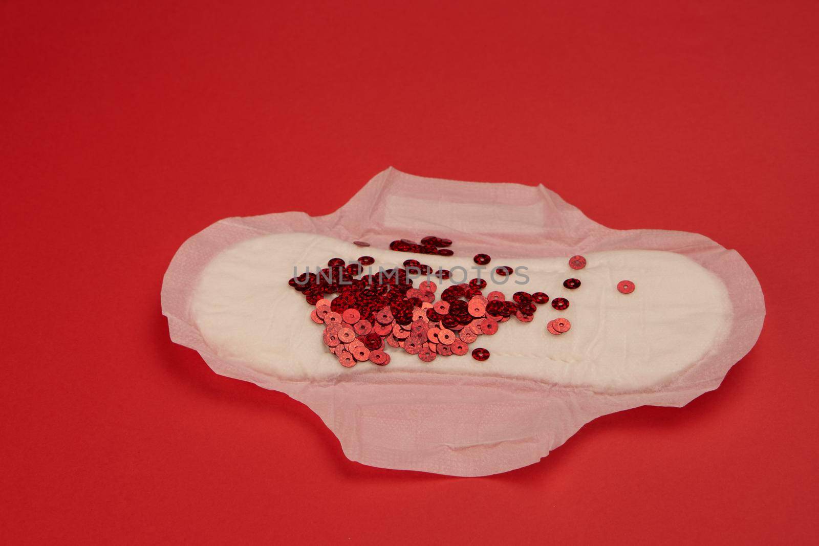 feminine pad blood menstruation hygiene red background. High quality photo