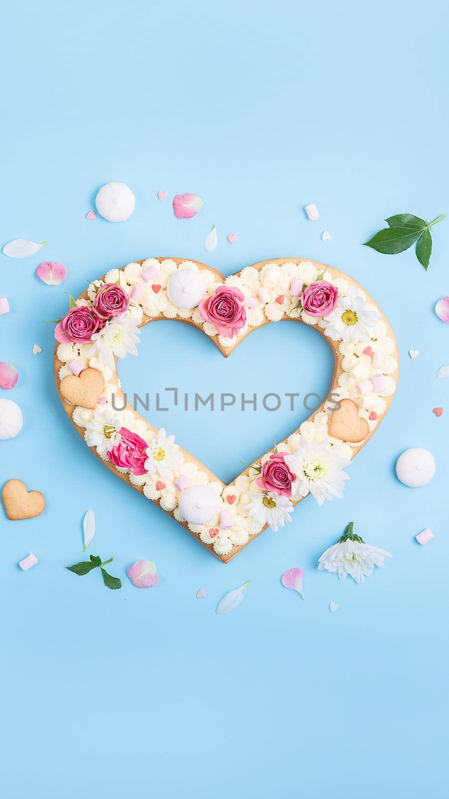 Valentine's Day heart-shaped cake with flowers as decoration. The concept of a gift to a loved one on a holiday. by vvmich