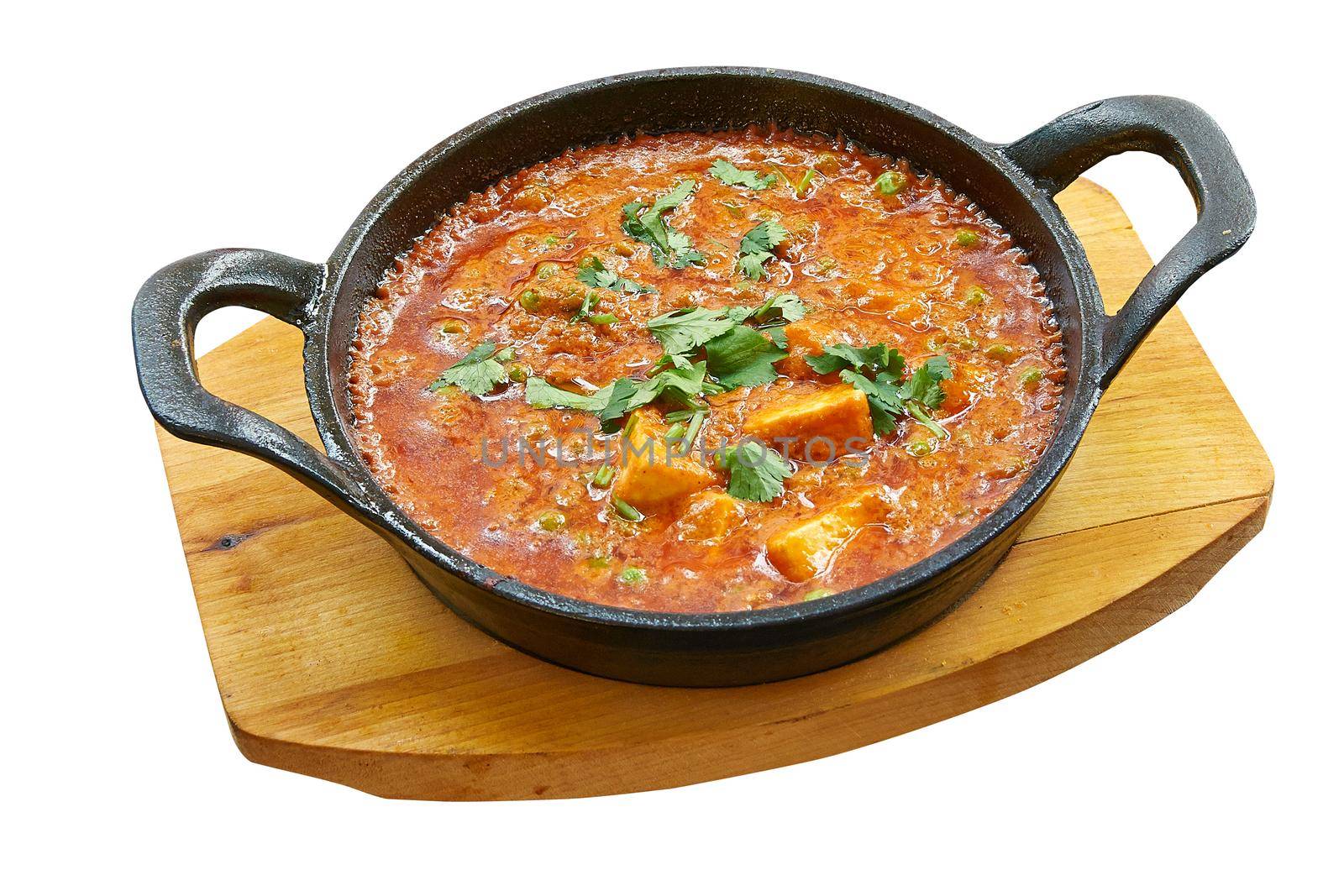 Overhead  shot of matar paneer baked in little pan. by pbombaert