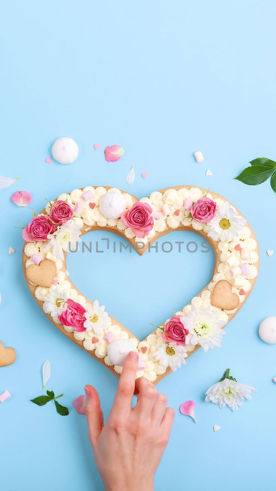 Valentine's Day heart-shaped cake with flowers as decoration. The concept of a gift to a loved one on a holiday. by vvmich