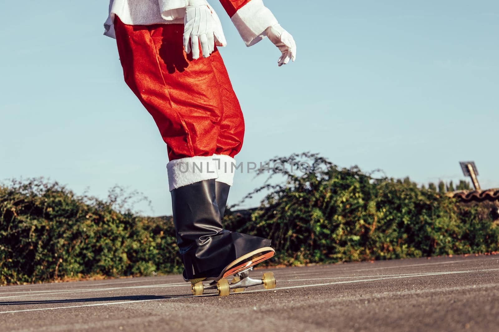 Close-up of santa legs skateboarding outdoors by ALVANPH