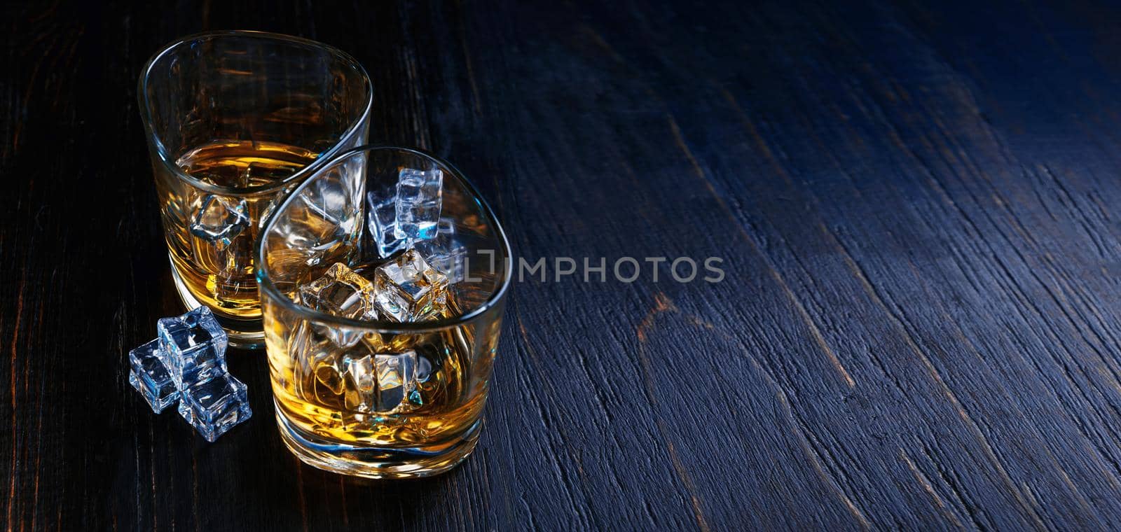 whiskey with ice in modern glasses