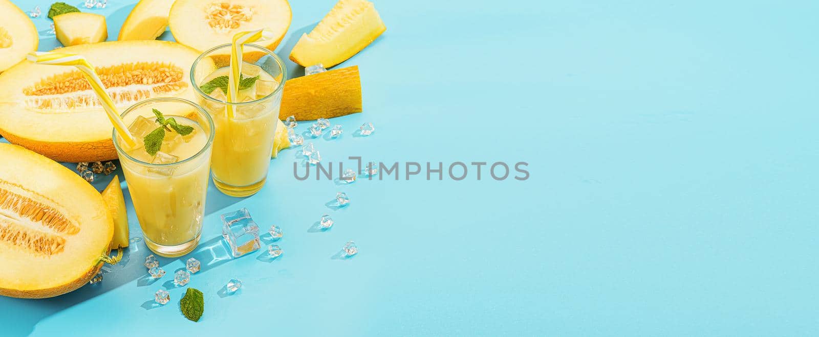 sweet and cold juice from melon in glasses against the background of melon sliced