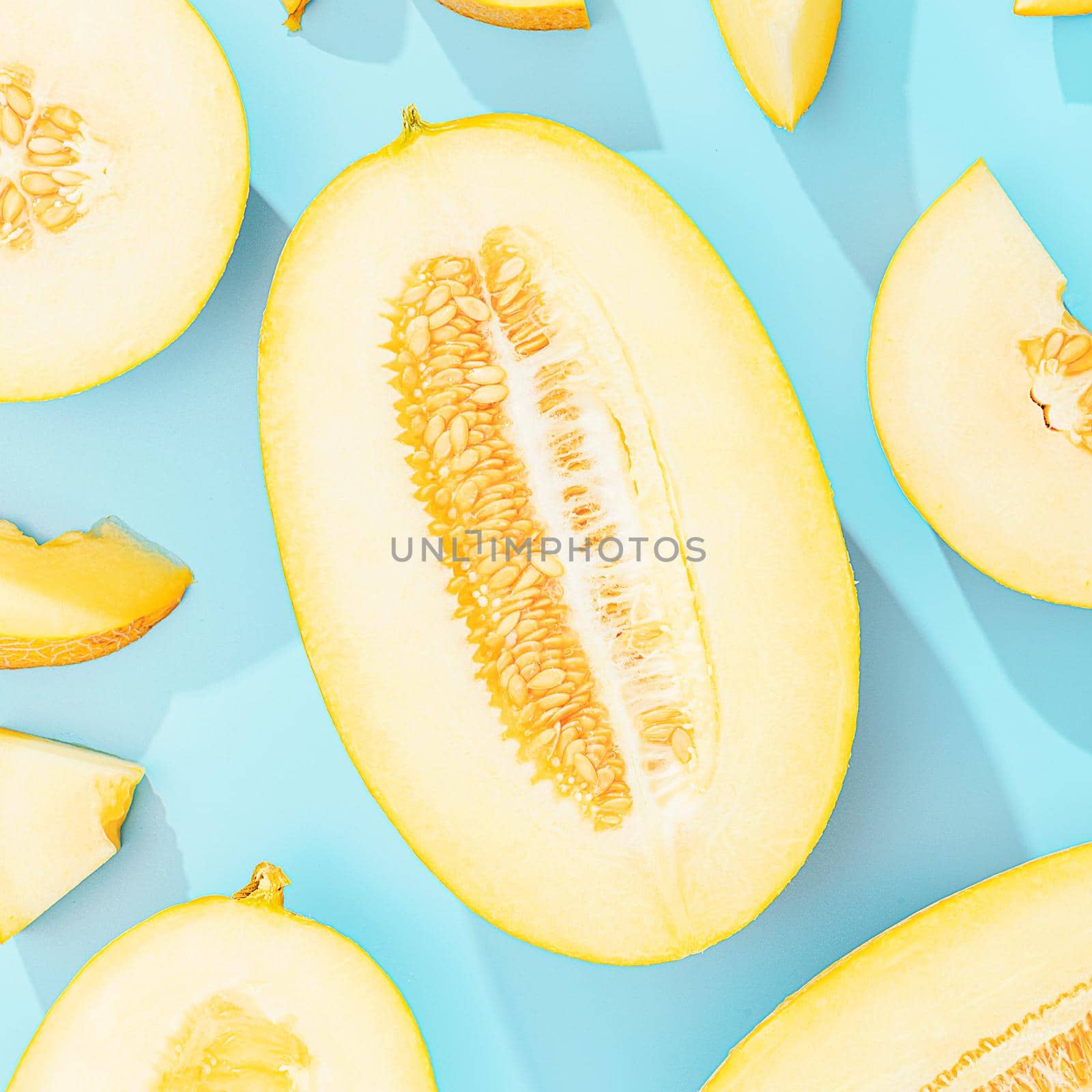 background with melon. sliced sweet and ripe melon on a blue background. by vvmich