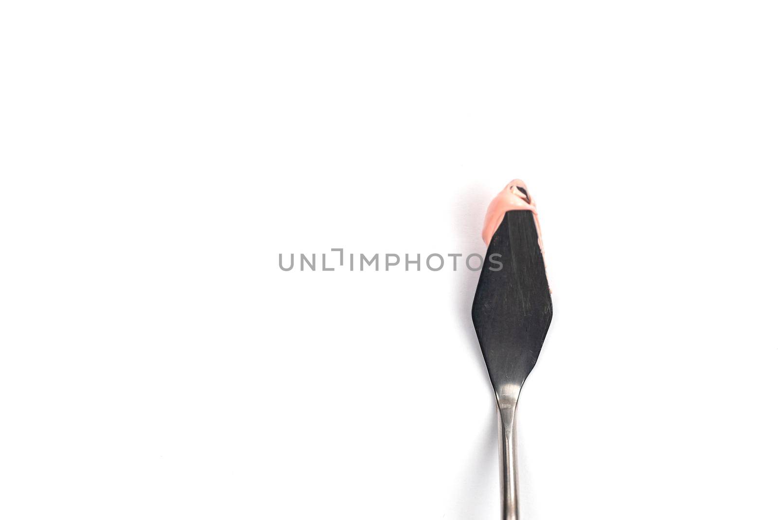 a painting palette knife isolated on a white background painting a pink with copy space