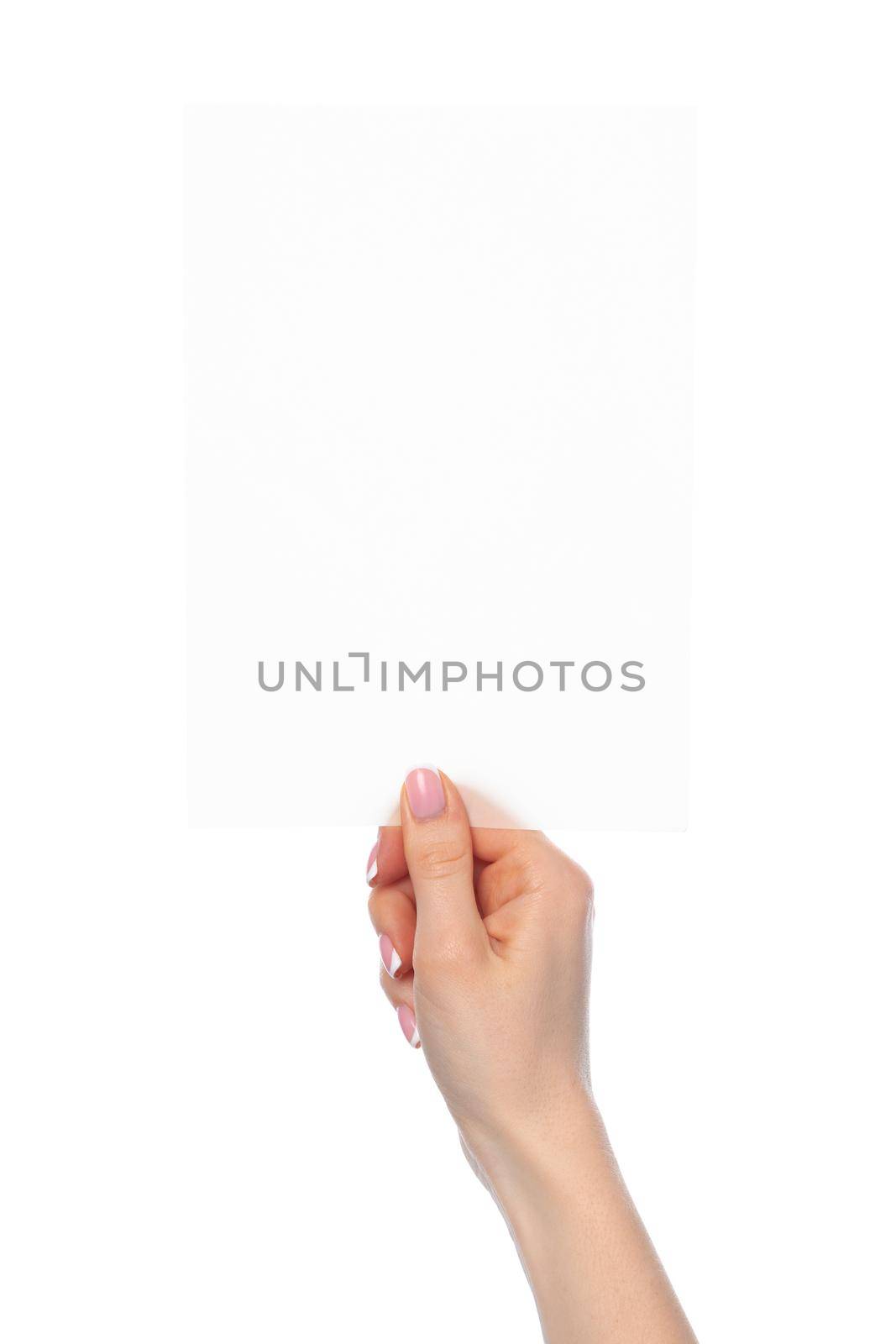 Female hand holding blank white sheet of paper isolated on white background