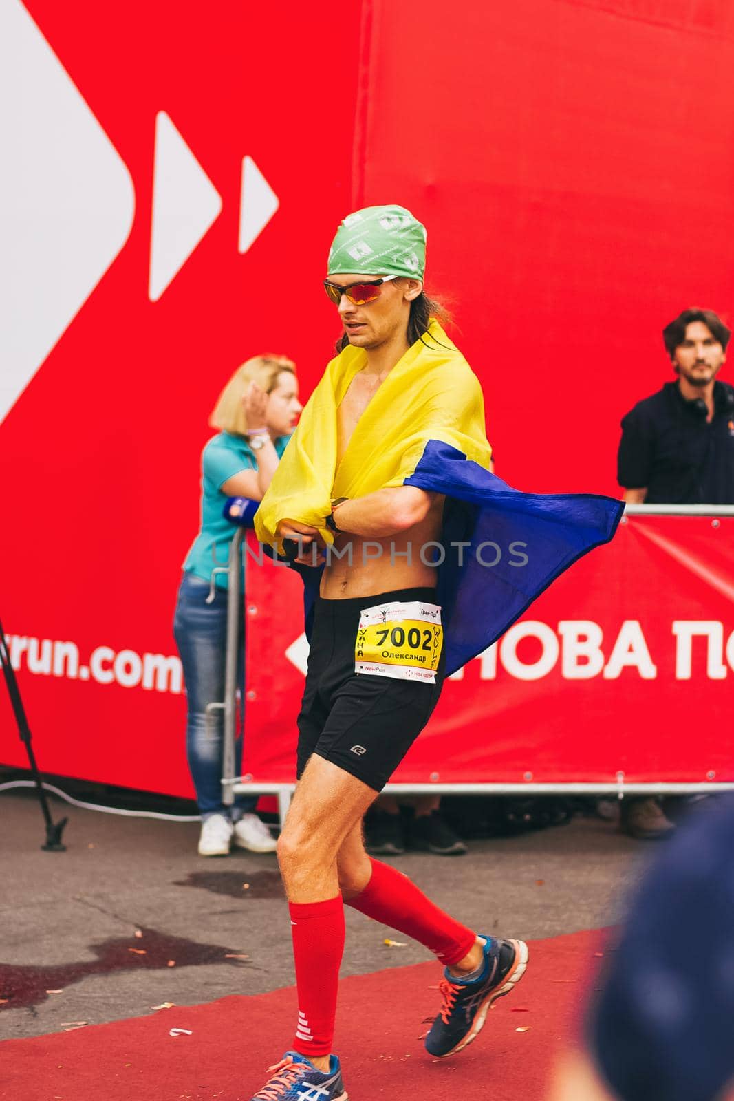 POLTAVA, UKRAINE - 1 SEPTEMBER 2019: A stylish man reaches finish line during Nova Poshta Poltava Half Marathon.
