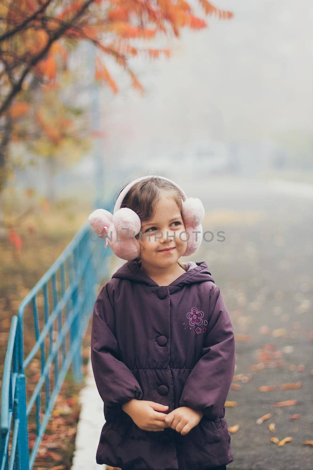 Adorable funny naughty little girl in park on beautiful autumn day