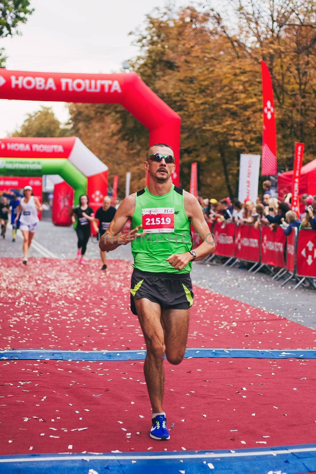 POLTAVA, UKRAINE - 1 SEPTEMBER 2019: A stylish man reaches finish line during Nova Poshta Poltava Half Marathon by mmp1206