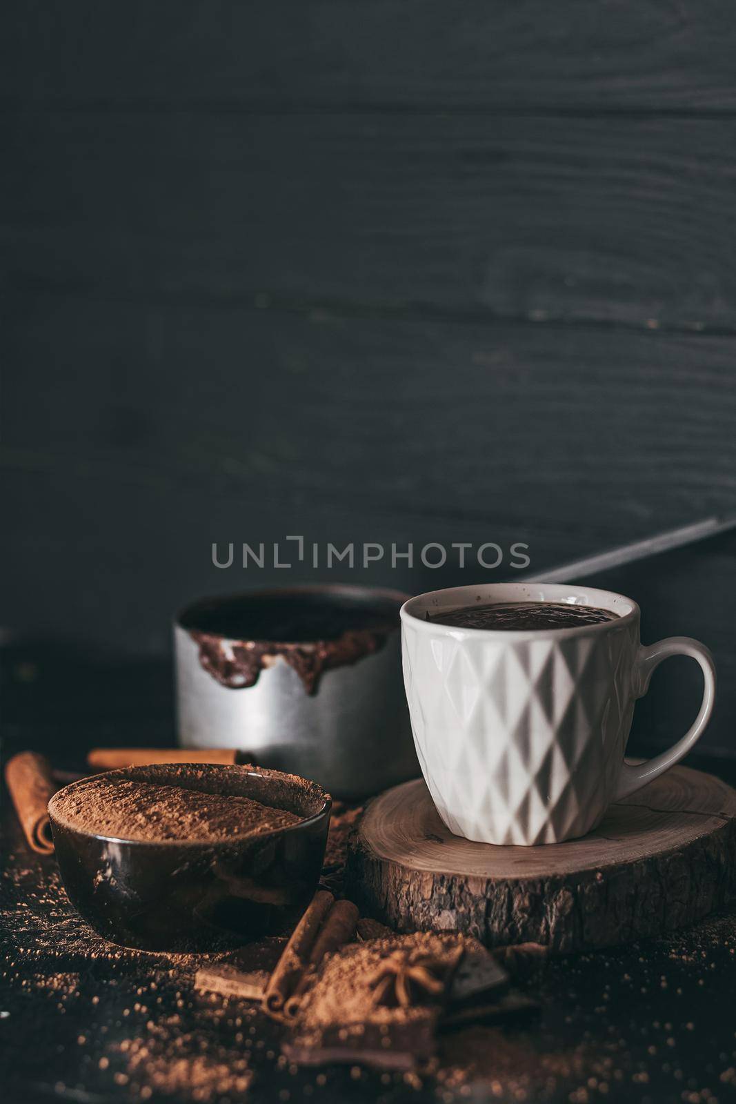 Cup of hot chocolate on dark background.