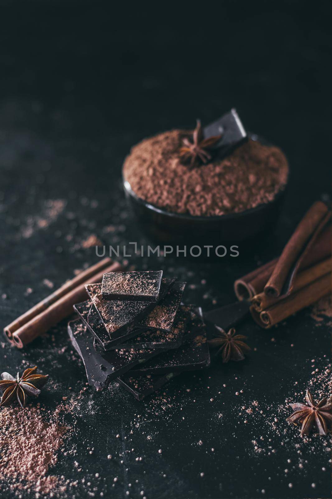 Chocolate bar pieces with cocoa powder on dark background, cope space by mmp1206