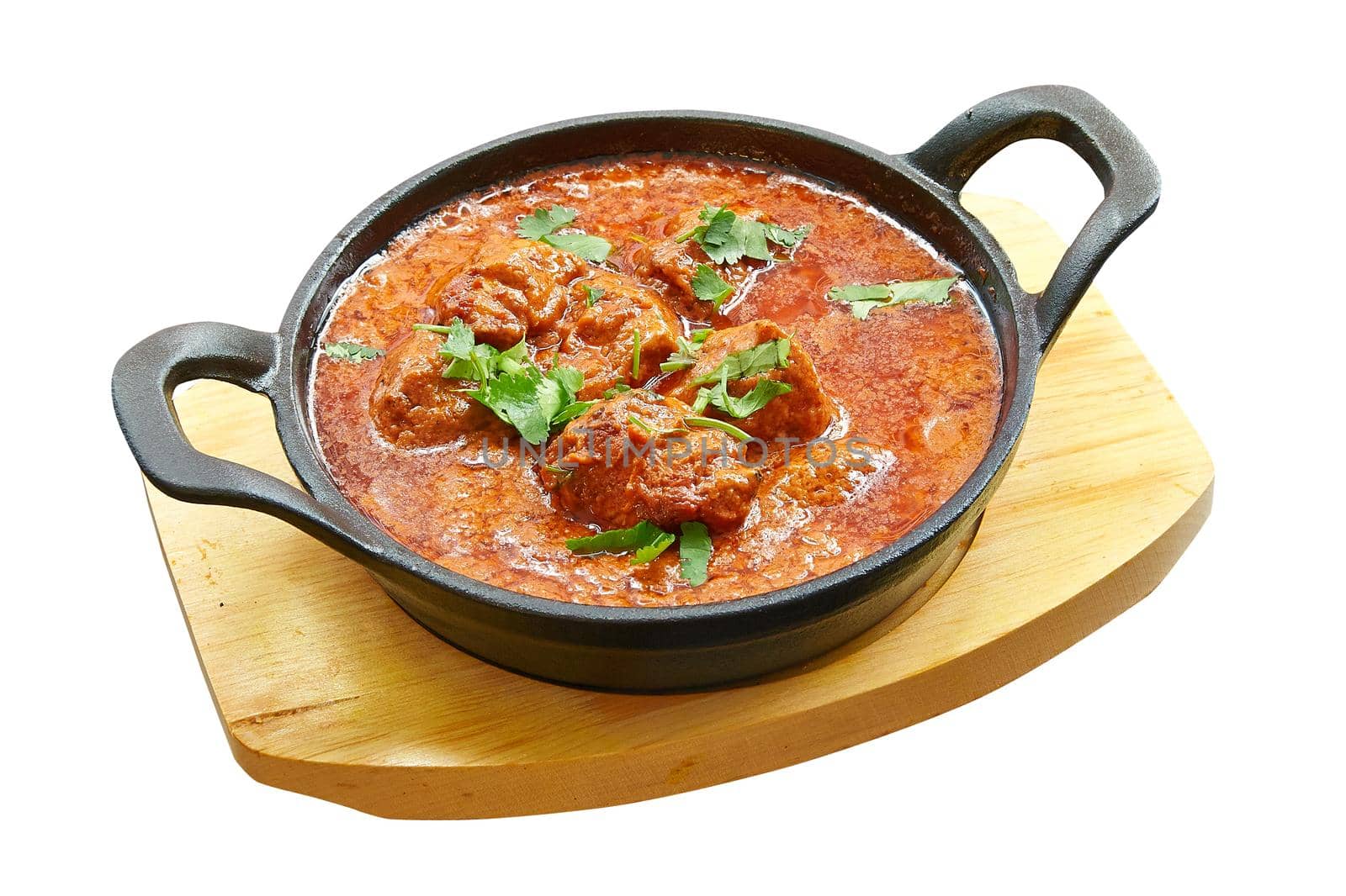 Overhead  shot of Chicken tikka masala baked in little pan. by pbombaert