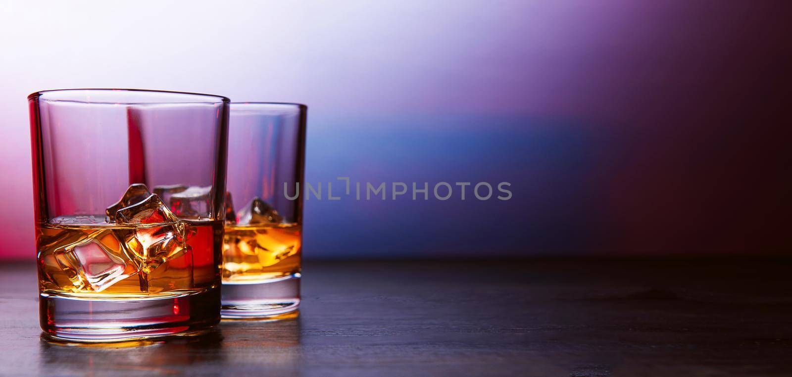 whiskey with ice in modern glasses by vvmich