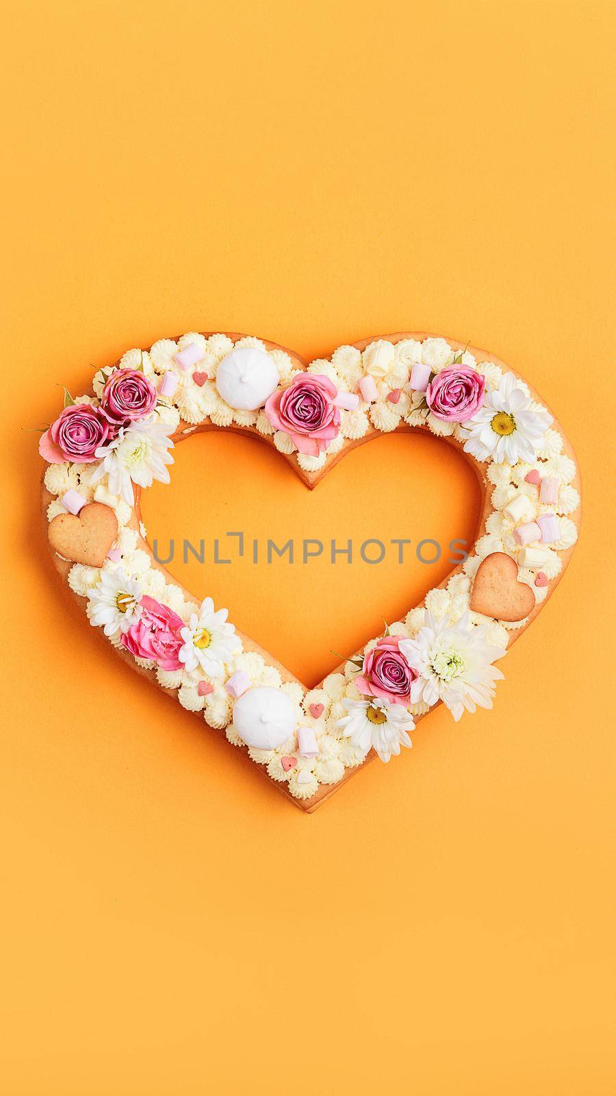 Valentine's Day heart-shaped cake with flowers as decoration. The concept of a gift to a loved one on a holiday. by vvmich