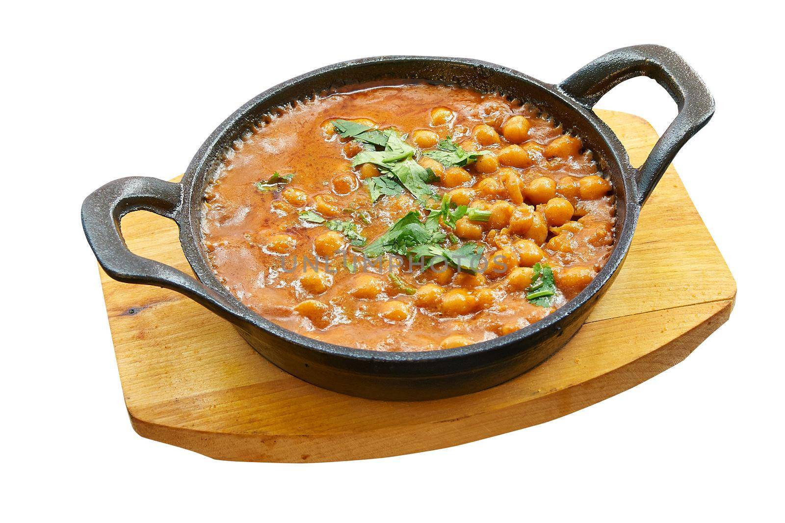 Overhead  shot of chana masala in little pan. Isolated on white with clipping path