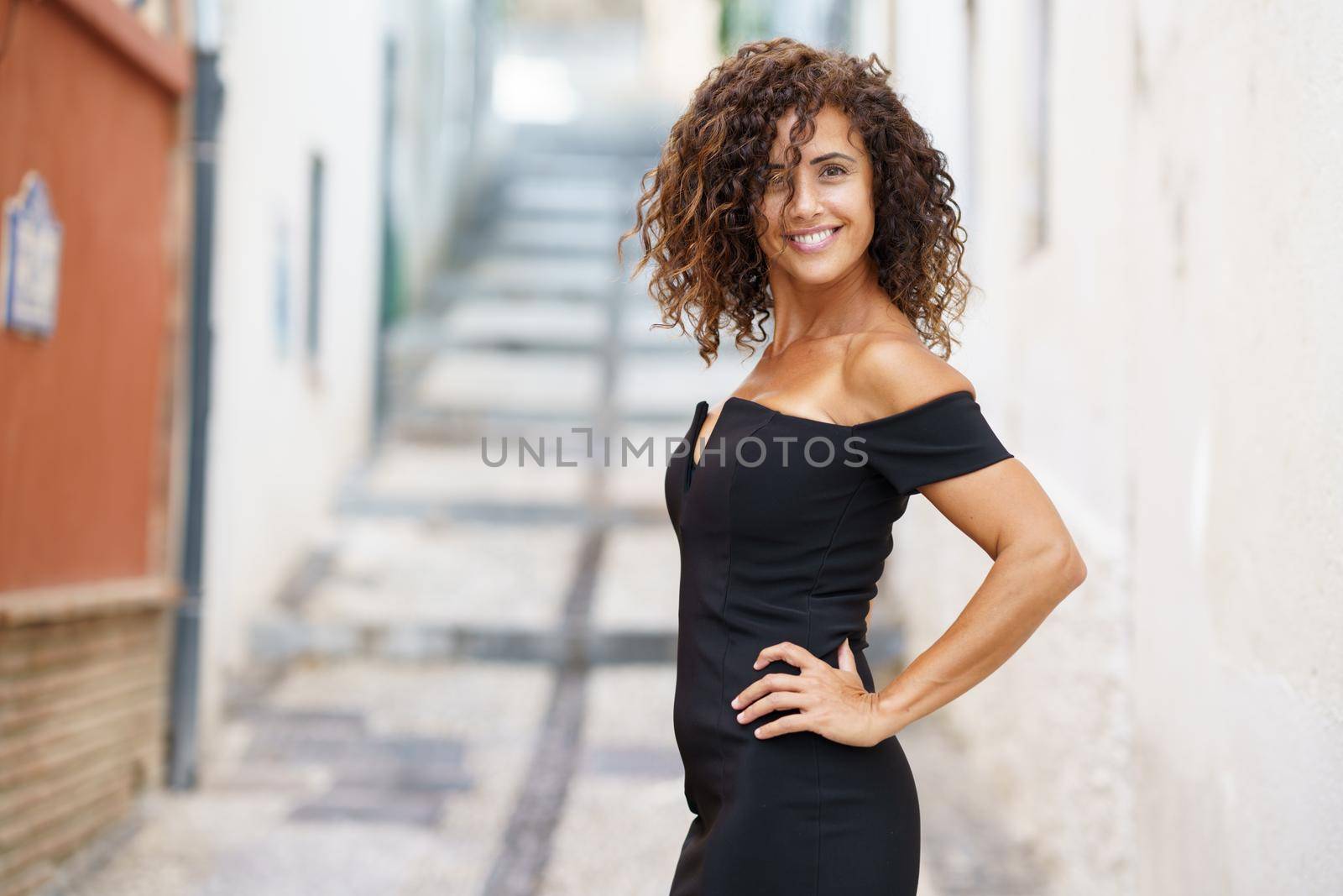 Beautiful brunette middle-aged woman wearing dress outdoors by javiindy