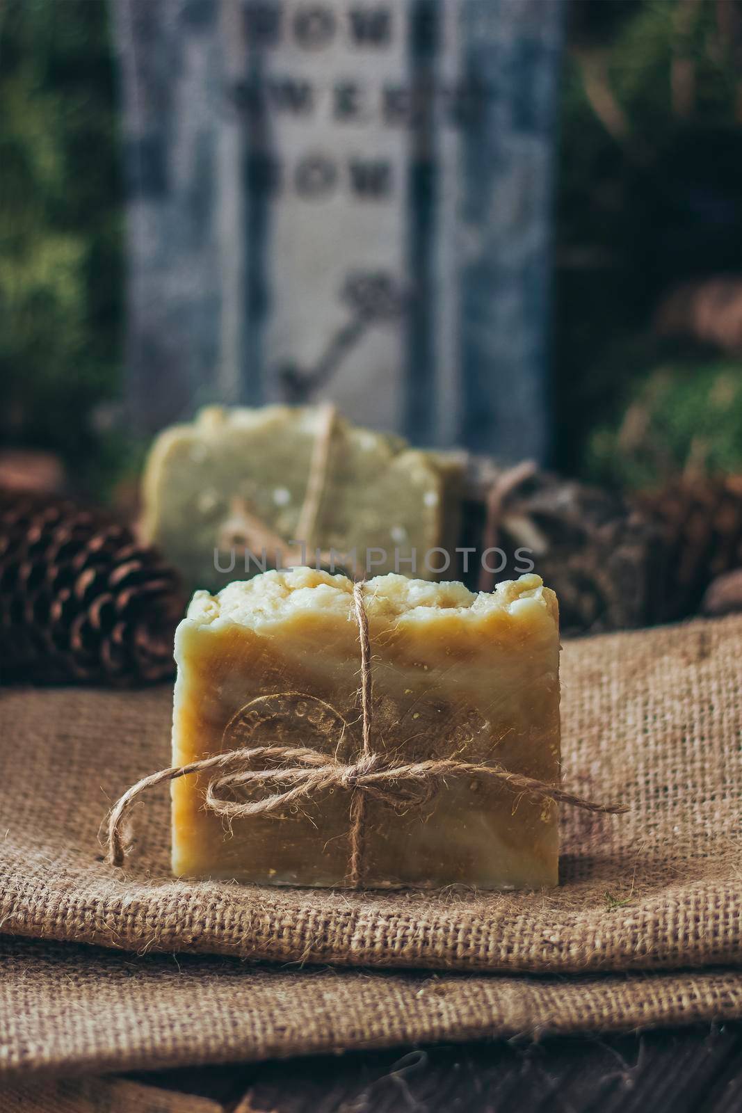 Pieces of beautiful natural handcrafted soap on wooden background with botanical elements, close up view. by mmp1206