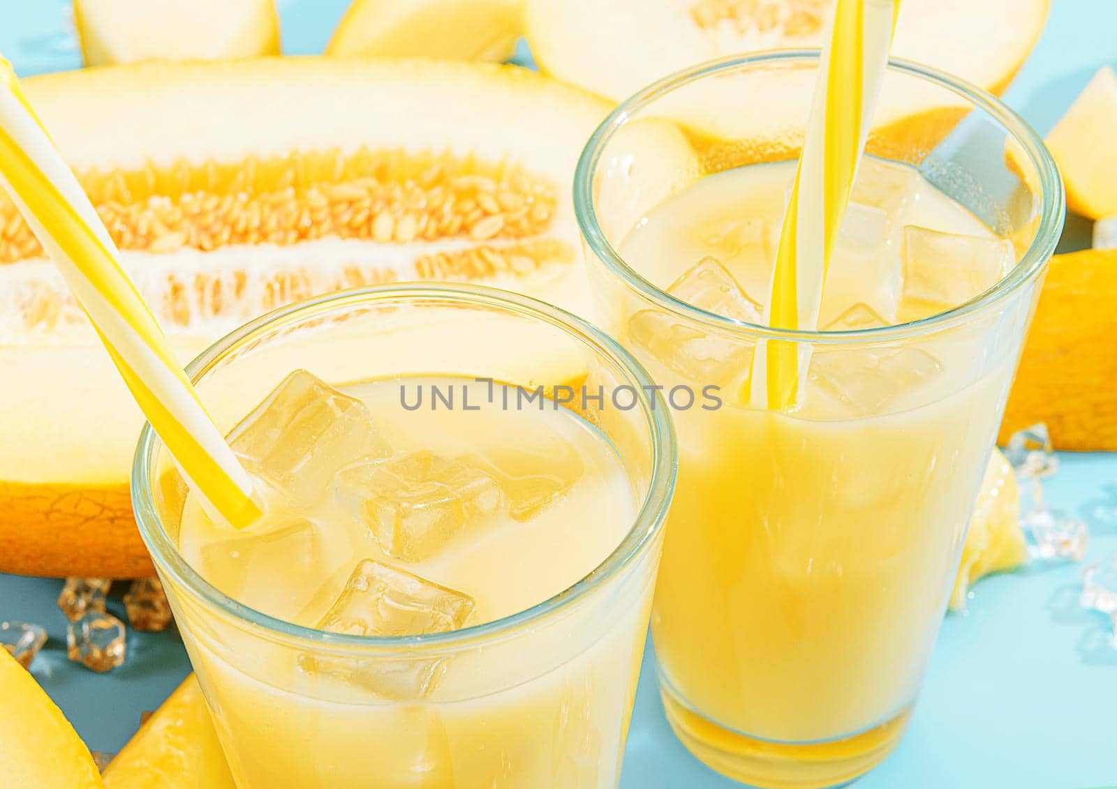 sweet and cold juice from melon in glasses against the background of melon sliced