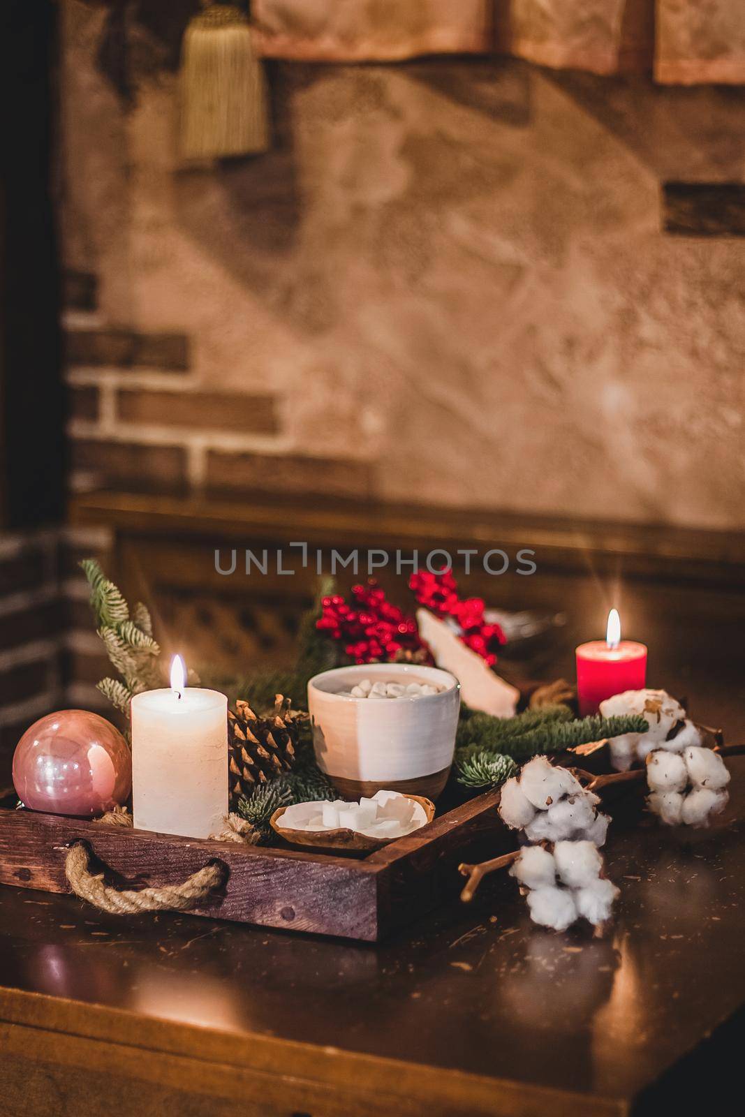 Christmas hot chocolate with mini marshmellows in an old ceramic mug with candles on a wooden background by mmp1206