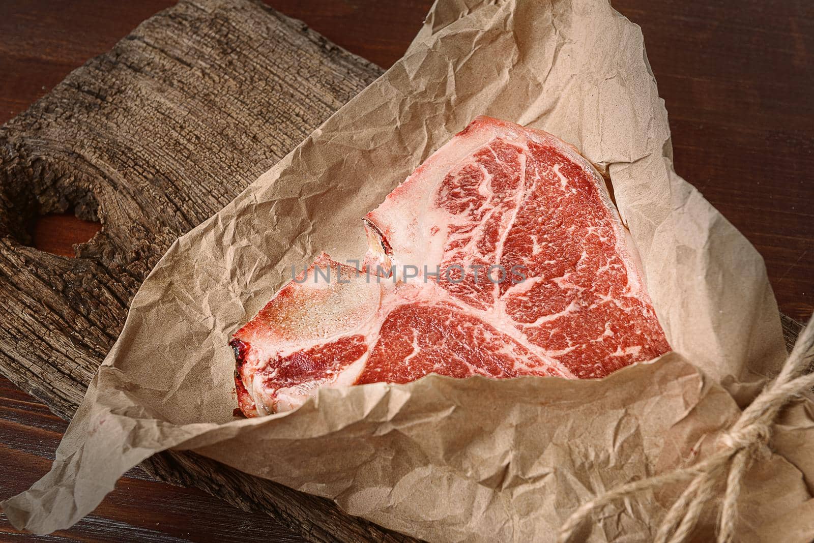 a piece of fresh farm meat t-bon non-GMO wrapped in eco-friendly wrapping paper by vvmich