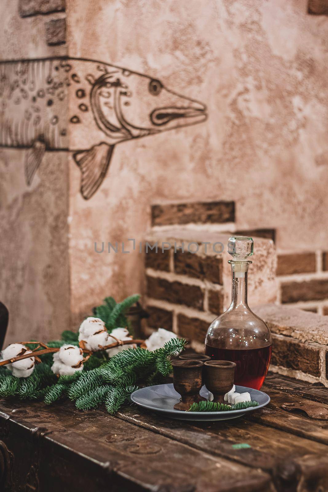 Christmas vintage background, craft alcohol drink and ancient dishes, fluffy fir branches and festive decor