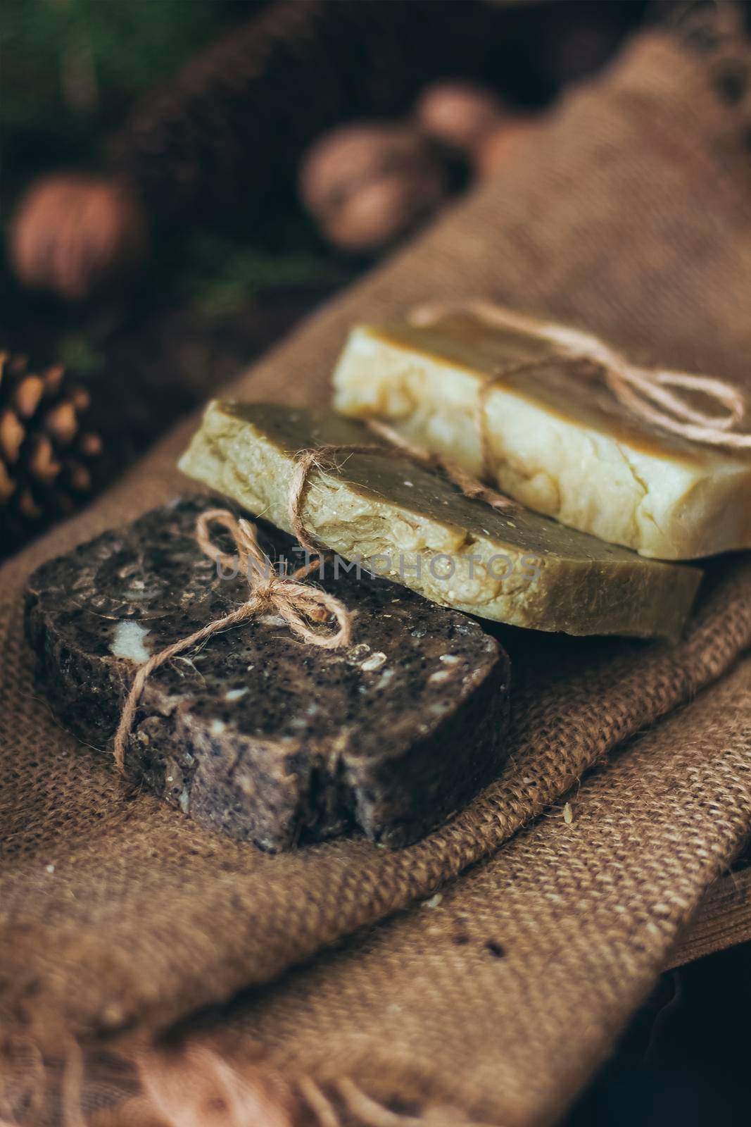 Pieces of beautiful natural handcrafted soap on wooden background with botanical elements, close up view. by mmp1206