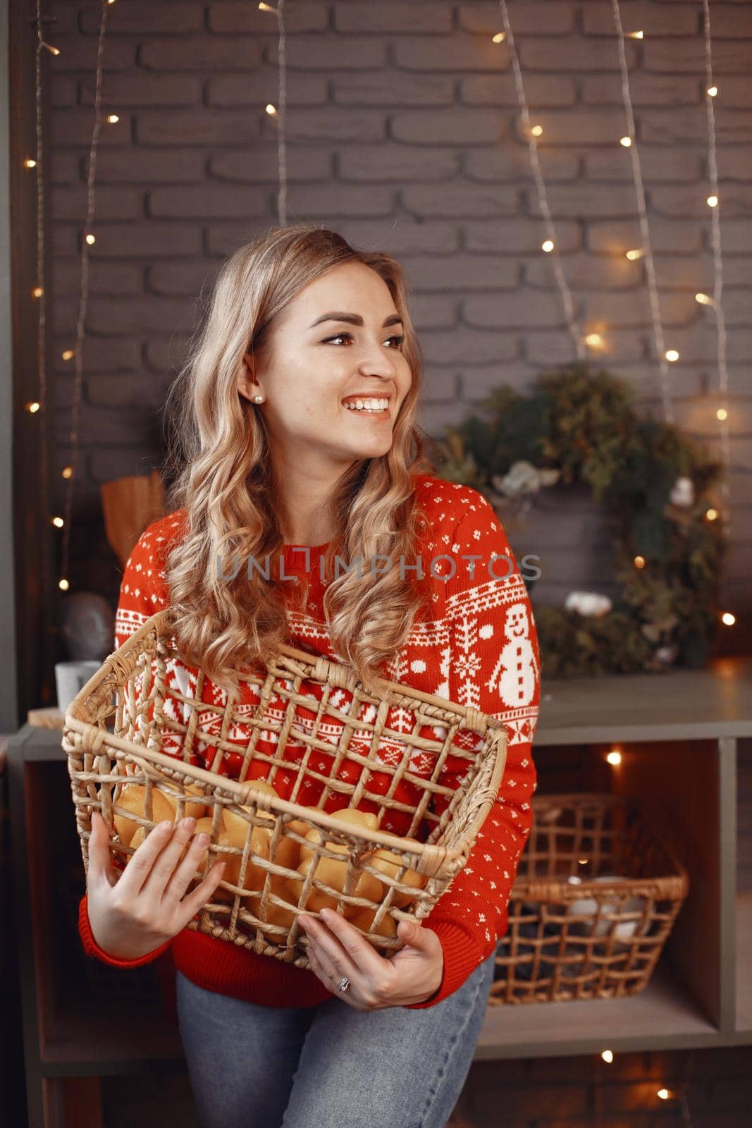 Woman in a white sweater. Lady look at the camera. Christmas concept.