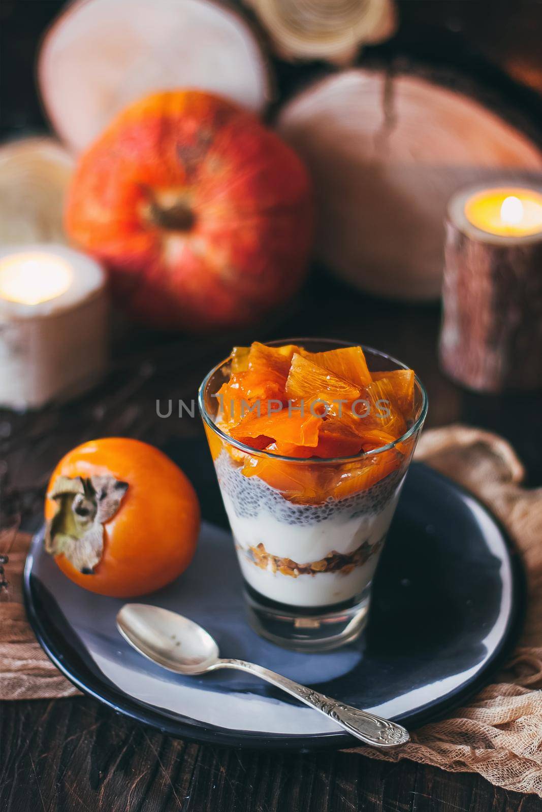Delicious breakfast: chia seed pudding and persimmon close up in a glass on the table. horizontal by mmp1206