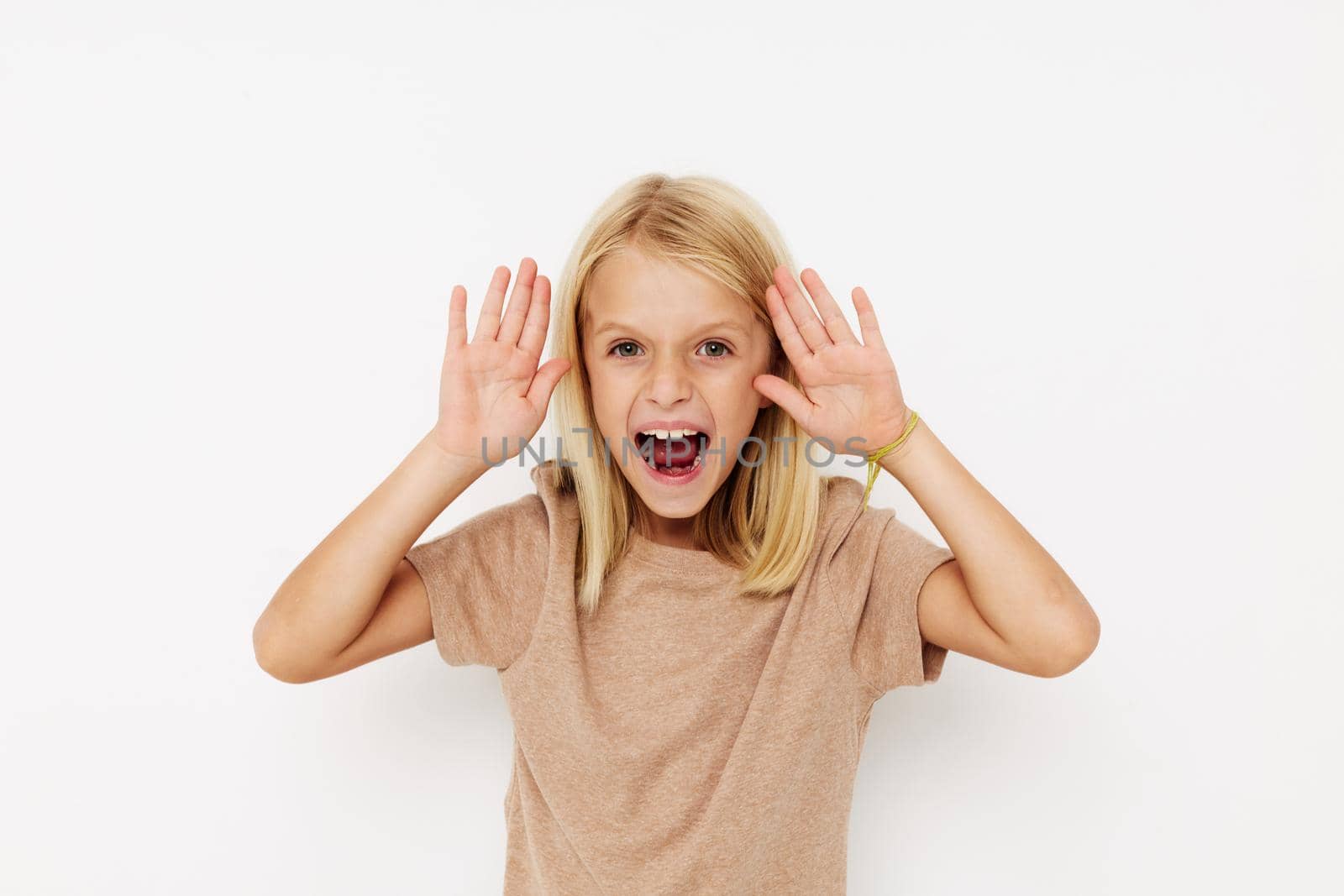 Portrait of a smiling little cutie with blond hair isolated background. High quality photo