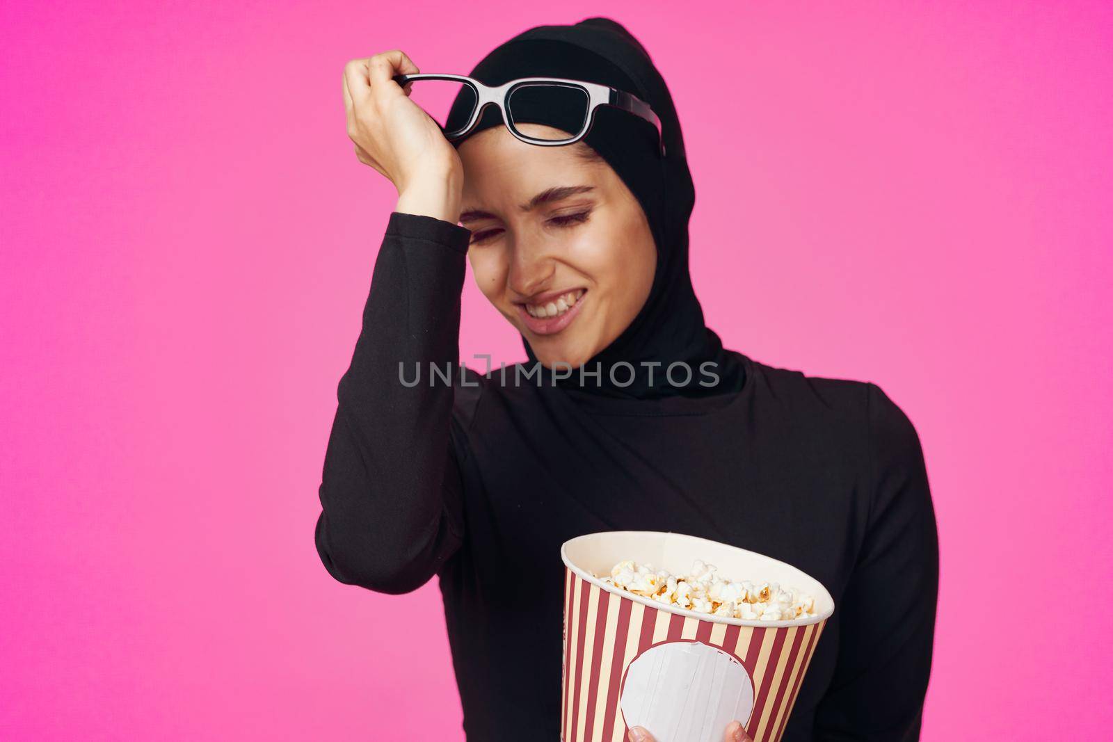 Muslim woman attractive look popcorn glasses movie watching isolated background. High quality photo