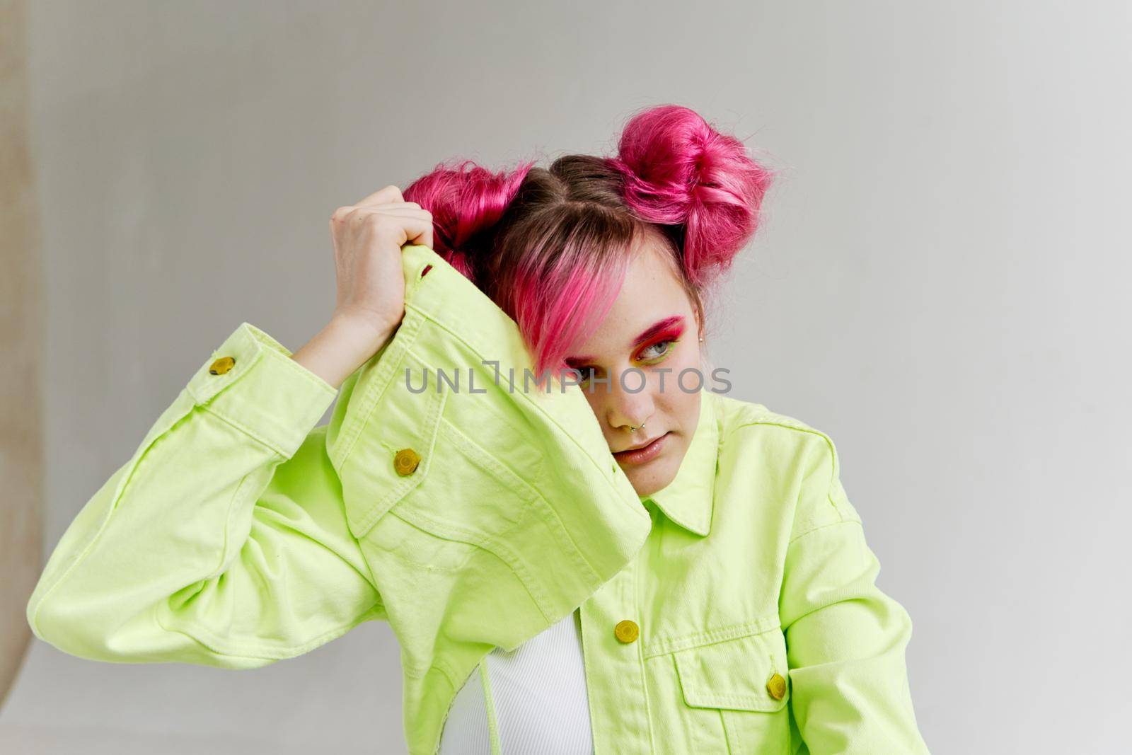 glamorous woman with pink hair bright makeup posing. High quality photo