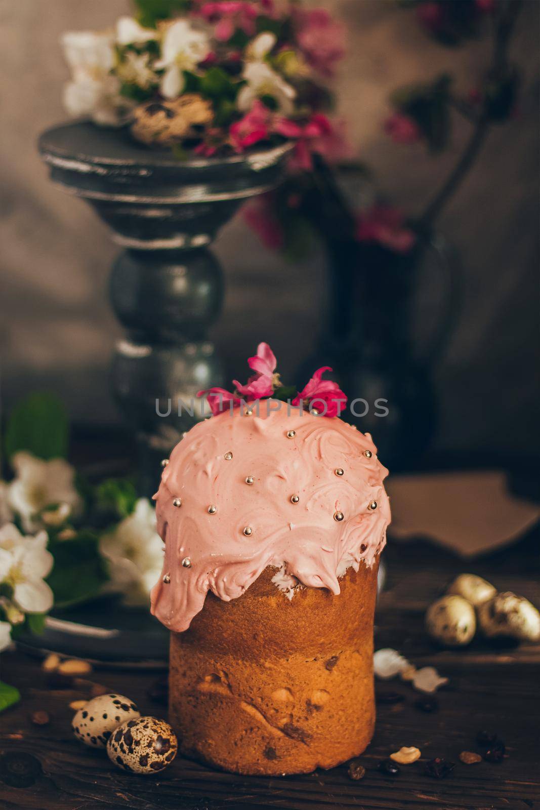 Traditional Russian Orthodox Easter bread kulich with apple blossom and colored eggs