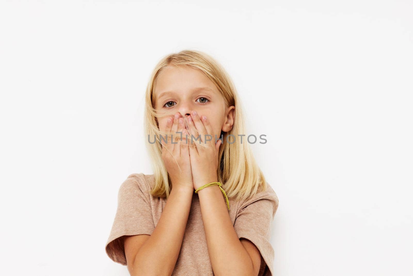 Positive little girl gestures with his hands isolated background. High quality photo