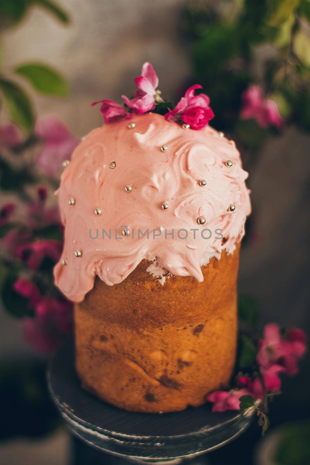 Traditional Russian Orthodox Easter bread kulich with apple blossom and colored eggs