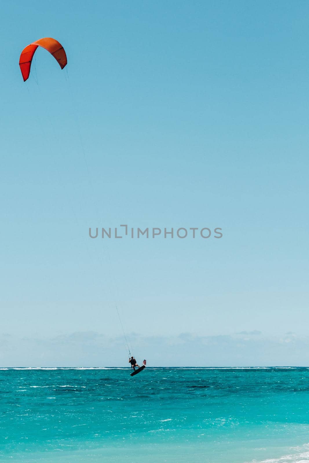 A man paragliding on Le Morne beach, Mauritius, Indian ocean on the island of Mauritius.