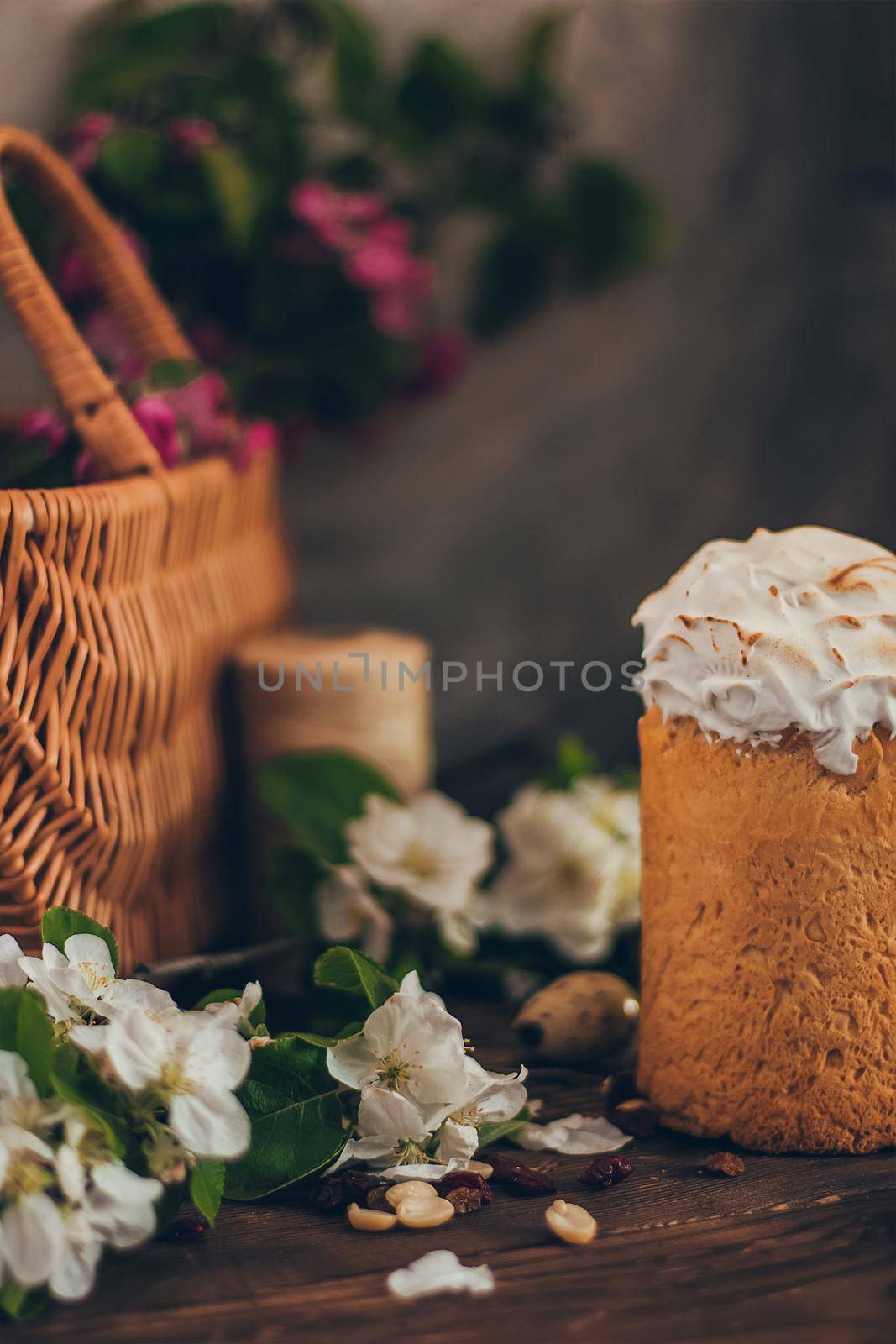 Traditional Russian Orthodox Easter bread kulich with apple blossom and colored eggs