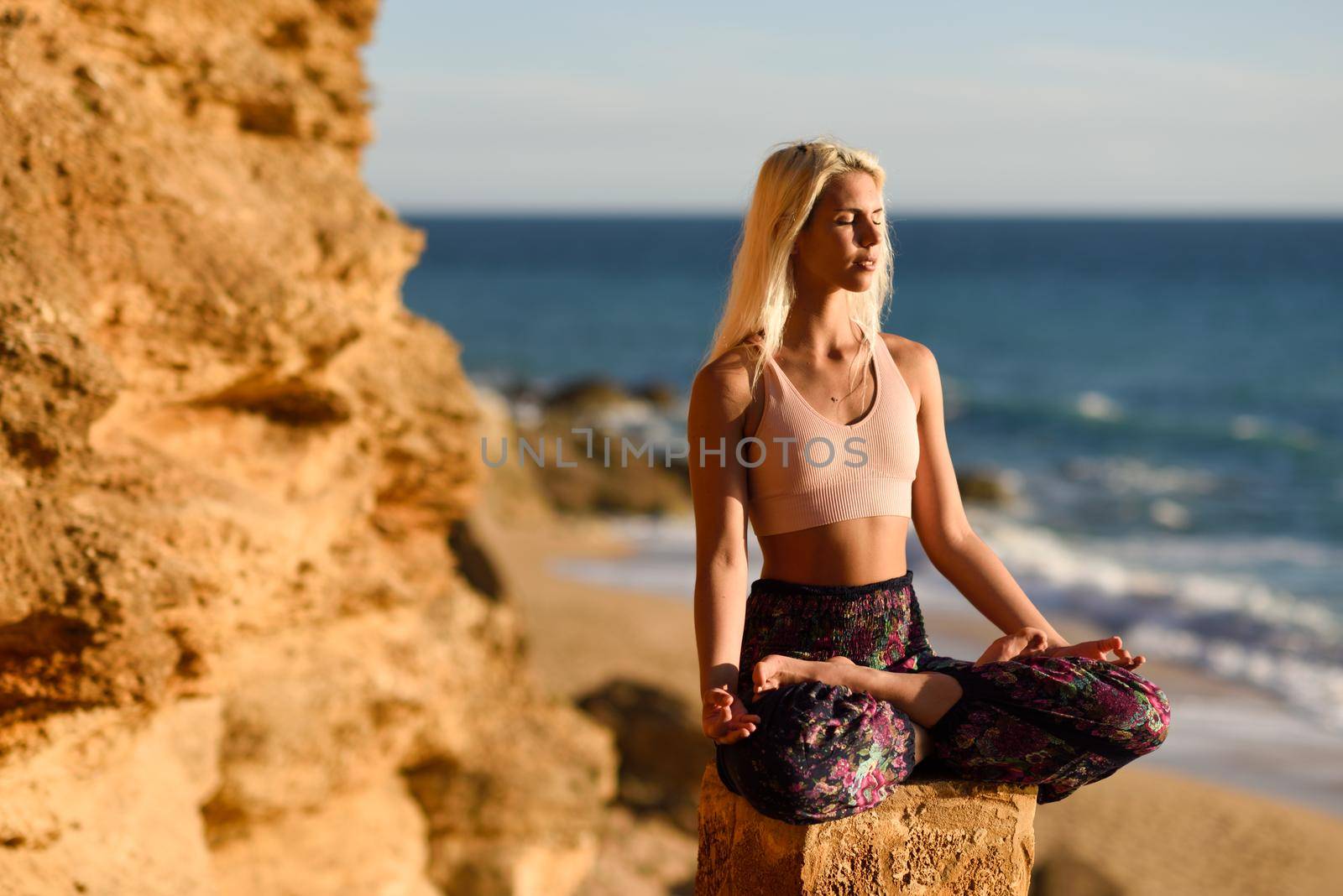 Woman enjoying the sunset on a beautiful beach by javiindy