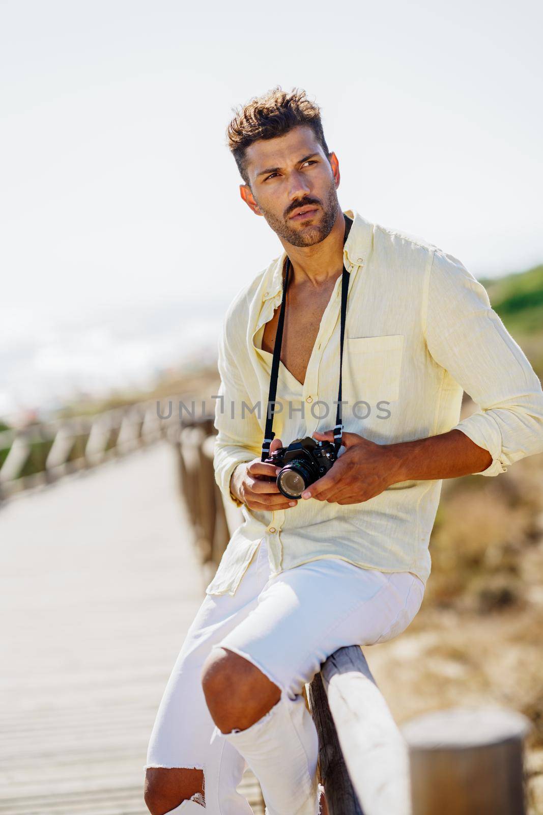 Handsome man photographing in a coastal area. by javiindy