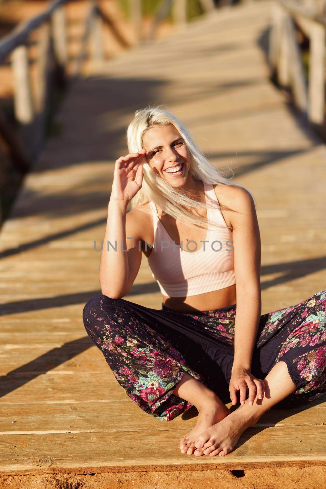 Smiling woman enjoying the sunset on a beautiful beach by javiindy