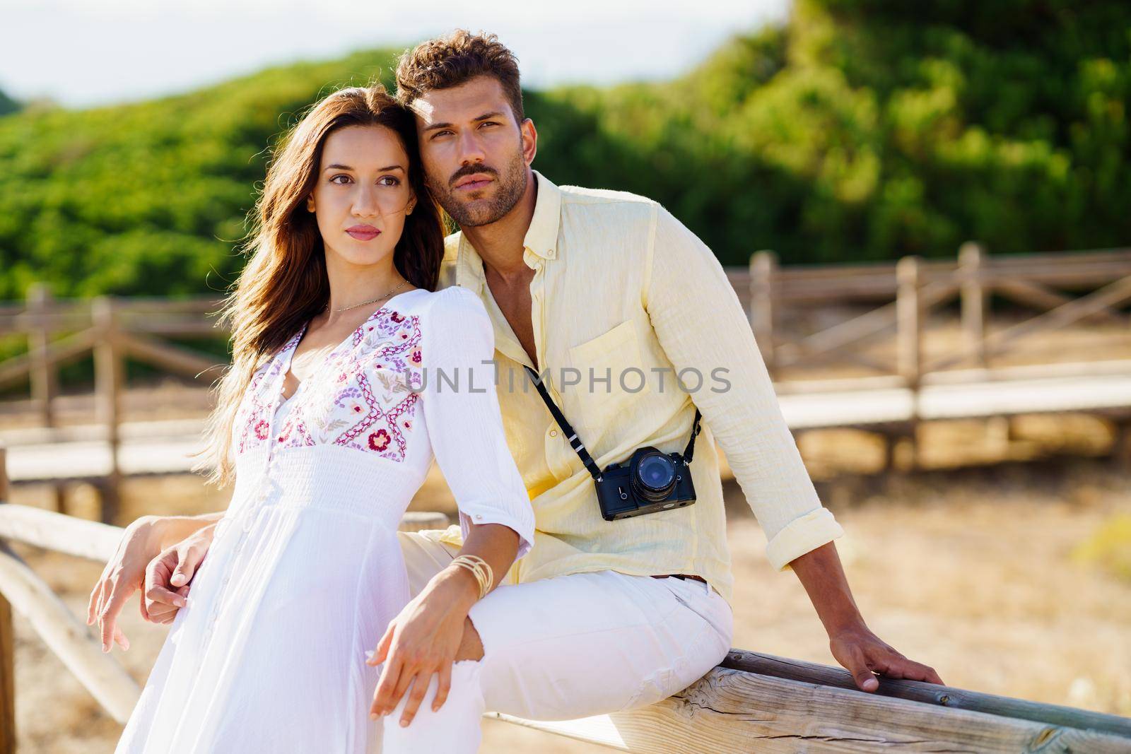 Young beautiful couple looking at the horizon in a natural area