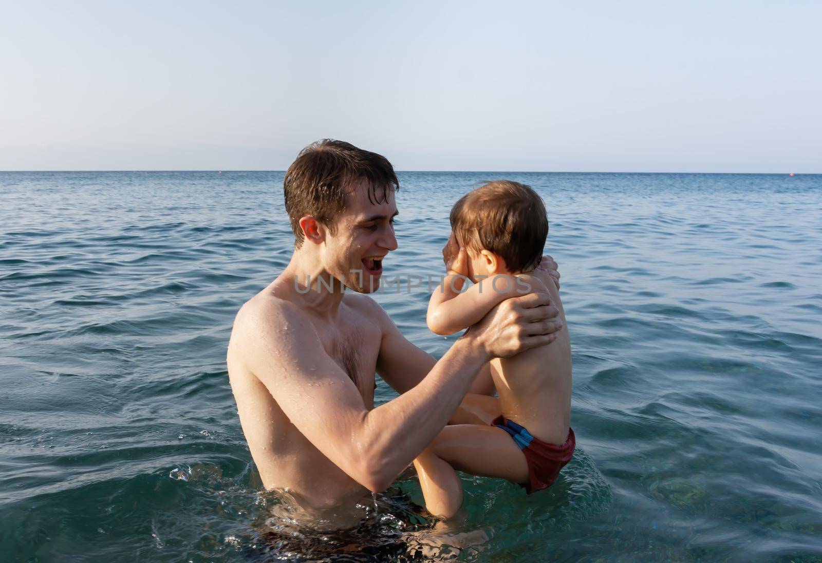 father and child in the sea by palinchak