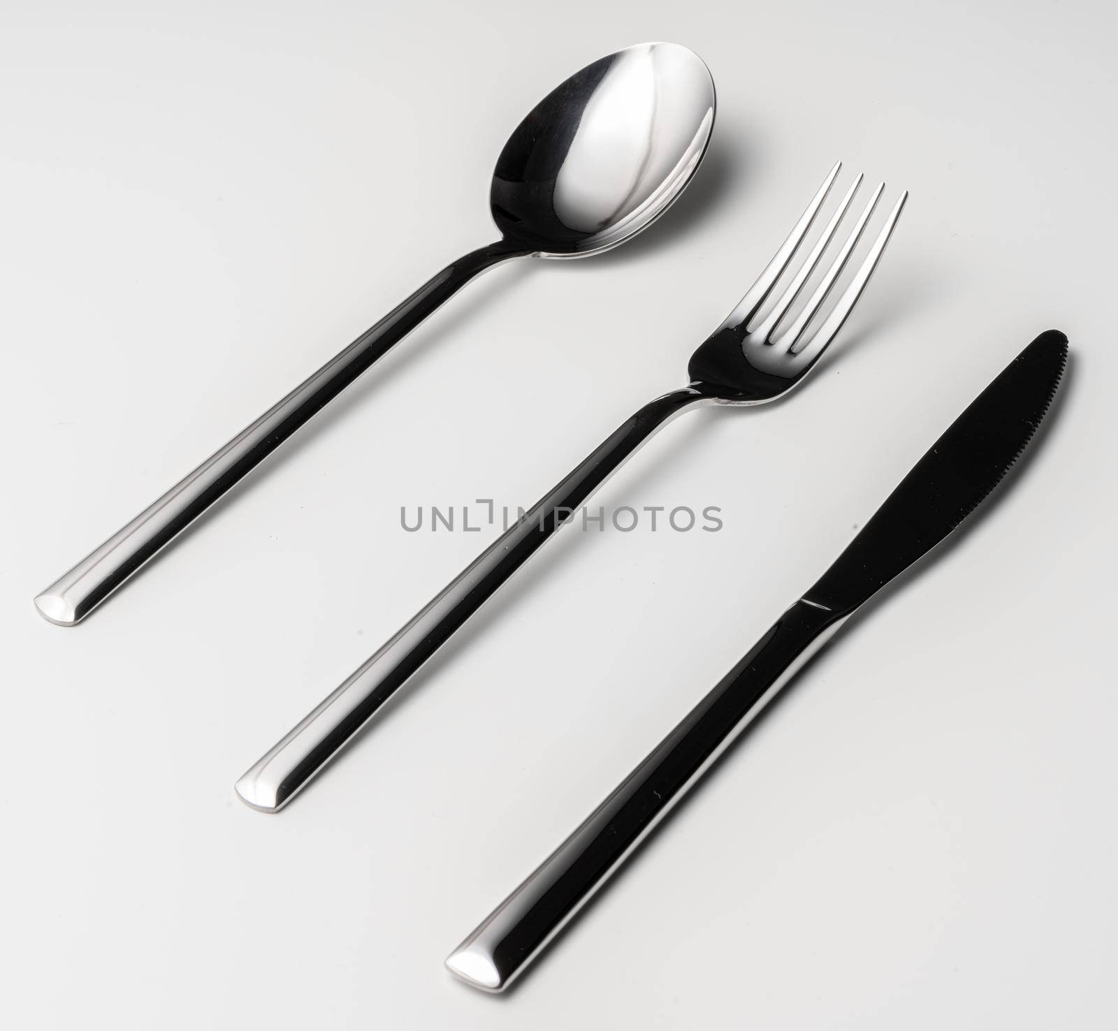 Spoon, fork and knife on a white background. High quality photo