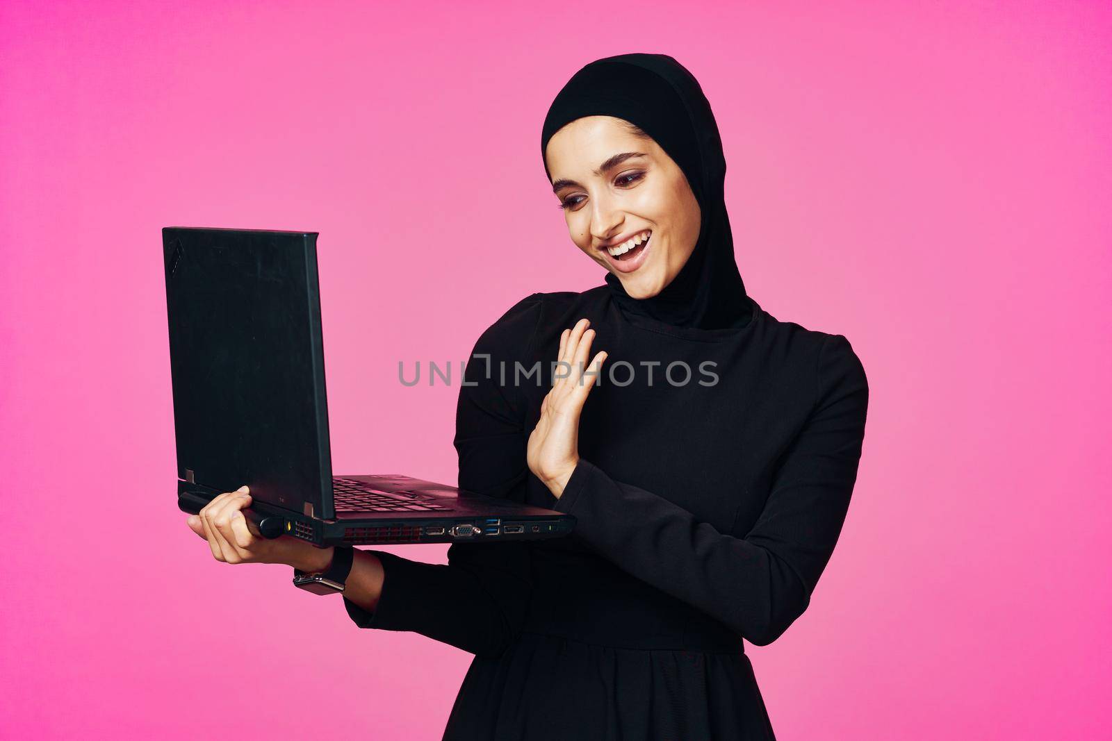 cheerful muslim woman with laptop education student internet technology. High quality photo